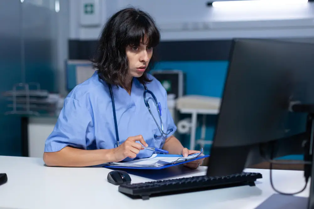 Hospital Billing Services - Paramedic looking at a computer's screen