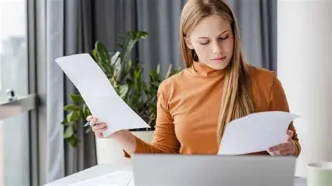 OBGYN Billing Services - A women looking at diff papers that presumably have some information