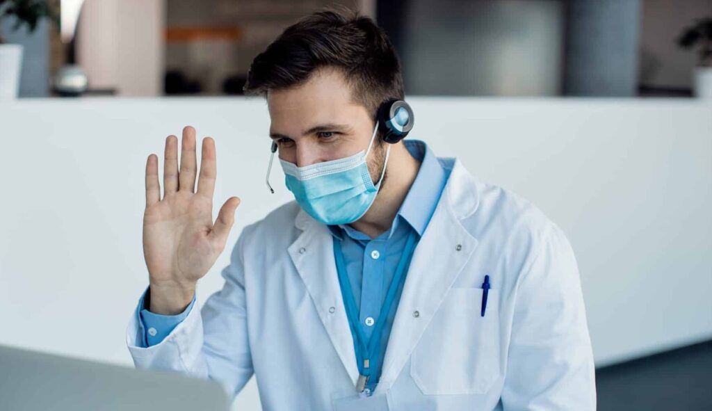 A front des staff greeting someone from out of frame