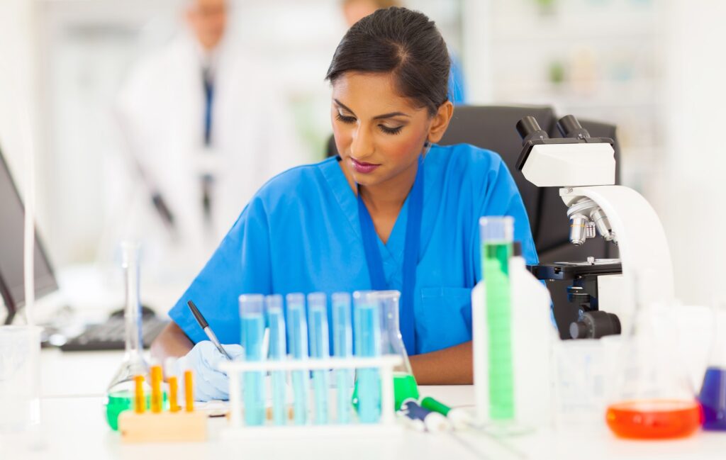 Laboratory Billing Services - A lab attendant writing her findings