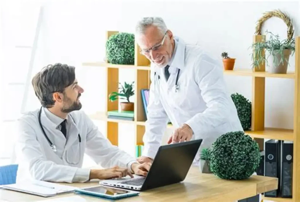 Urology Medical Billing & Coding-Doctors looking at a laptop
