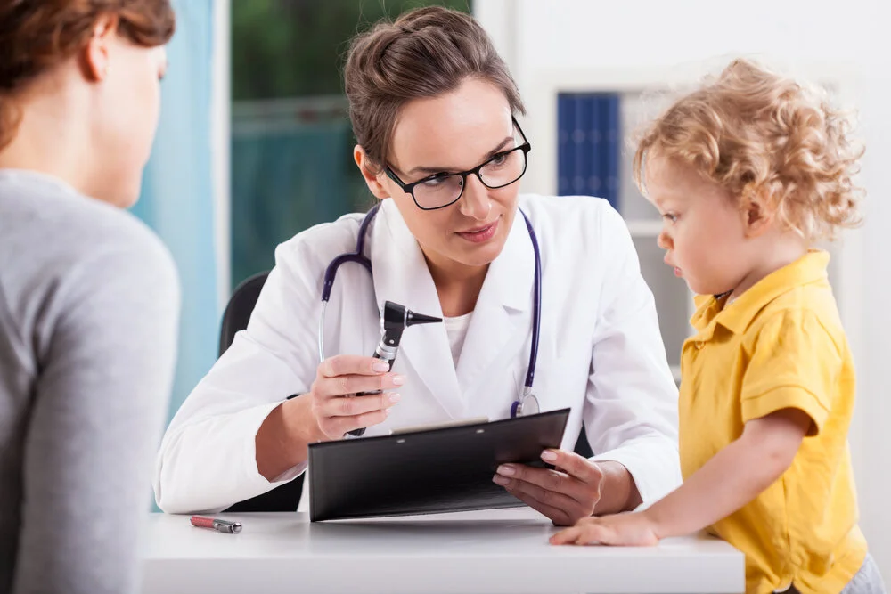 A child looking at doctor